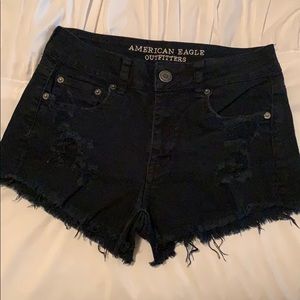 High waisted black distressed shorts.